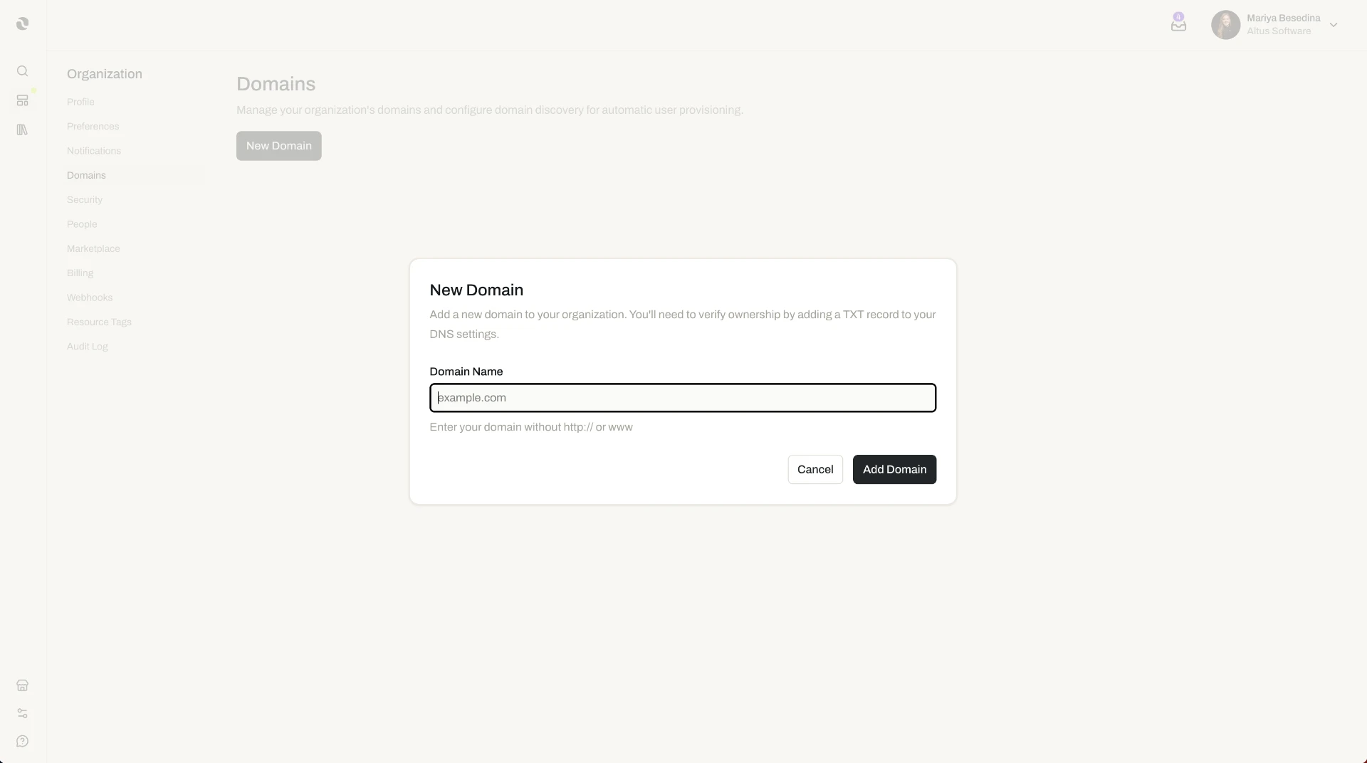 The New Domain modal in Organization Settings, where an administrator enters a domain name to add and later verify via a DNS TXT record.
